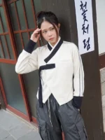 Front view of BABYMONSTER x YBSY Hwarang Hanbok Jacket in white featuring traditional inspired styling and modern streetwear design