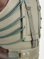 Extreme close-up shot of the green side lacing cords, canvas webbing straps, and brass rivets on the Bane tactical leather vest.