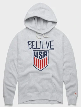 Front view of Homage Ted Lasso Believe x USA Crest Hoodie with USA crest graphics and relaxed fit