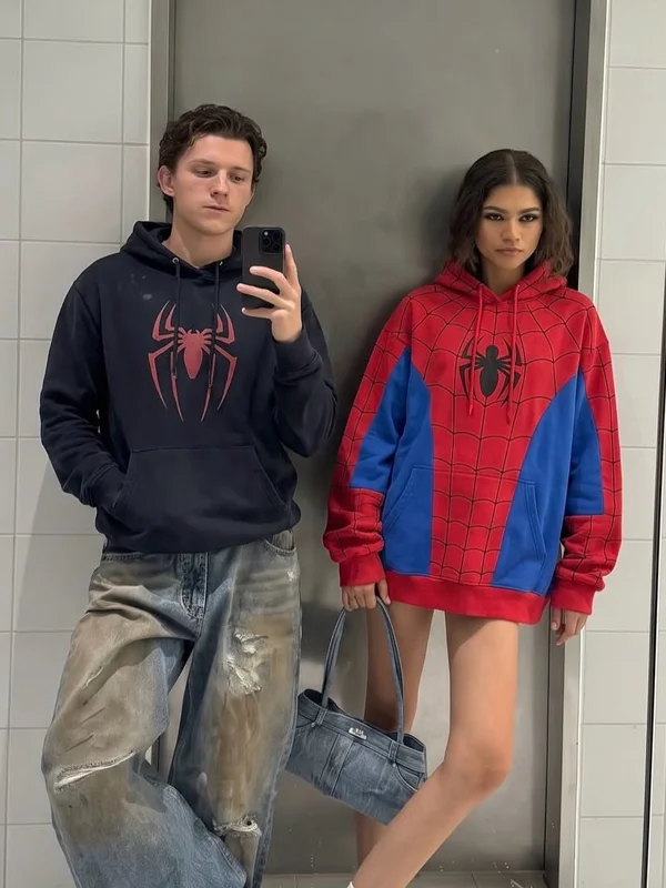Spiderman Tom Holland And Zendaya Hoodie Couple View Couple view of Spiderman Tom Holland And Zendaya Hoodie featuring matching superhero-inspired hoodies and coordinated casual styling