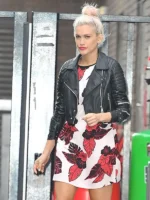Ashley Roberts wearing black leather jacket and floral dress walking outside studio