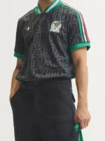 Mexico embroidered jersey front close-up with black carbon pattern, green V-neck collar, Trefoil logo and chest crest
