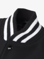 Close-up of the black and white striped rib-knit collar and top snap on the Pikachu varsity jacket.