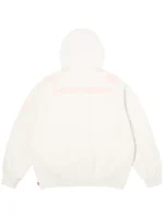 Back view of the white Supreme Football Jersey hoodie with subtle pink shoulder numbers and embroidered upper-back lettering.